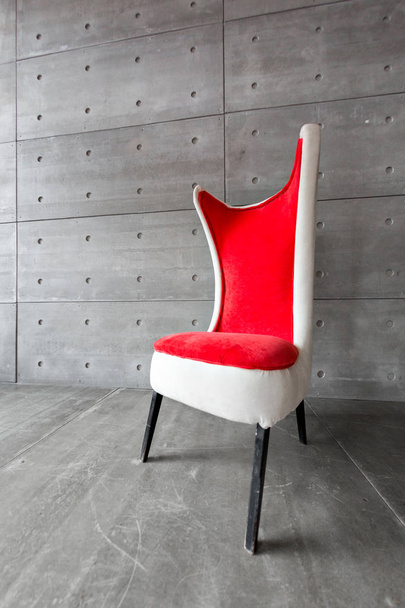 modern red chair and concrete wall. copy space - Фото, изображение