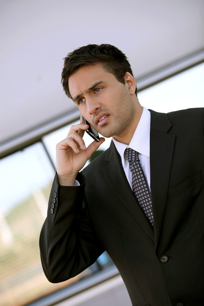 Concerned businessman holding cellphone - Fotoğraf, Görsel