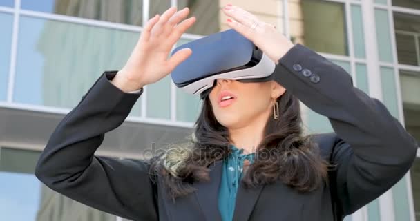 Female corporate executive holding VR headset experiencing 360 augmented reality - Footage, Video