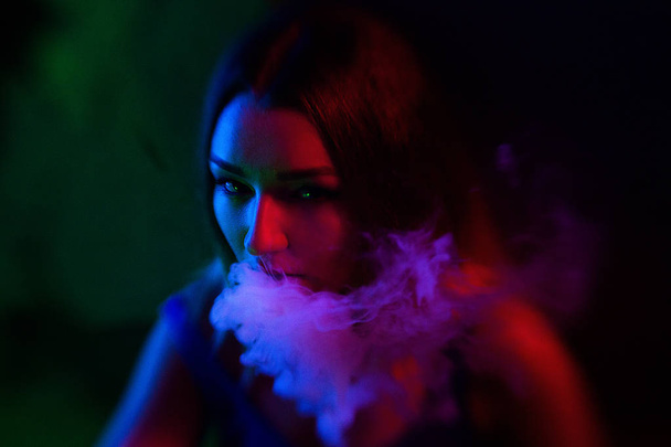 Fashion art portrait of beauty model woman in bright lights with colourful smoke. - Photo, Image