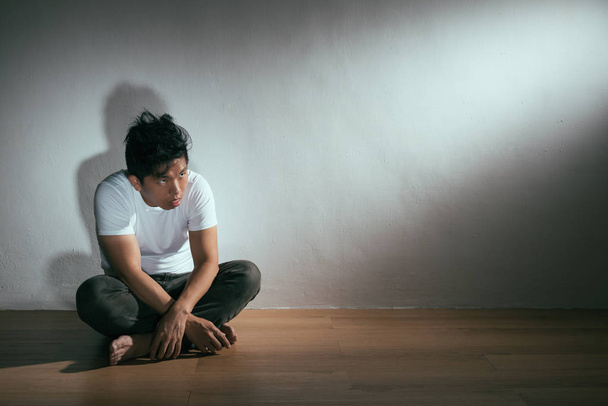 young autism patient man sitting on wooden floor - 写真・画像
