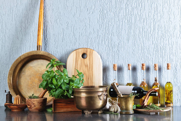 Vintage kitchen utensils with bottles of olive oil. - Photo, Image