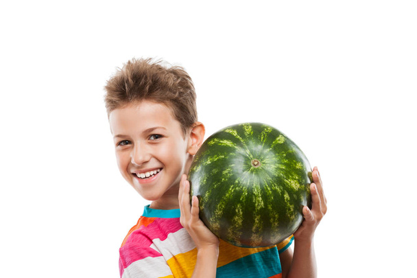 Handsome smiling child boy holding green watermelon fruit - Foto, Bild