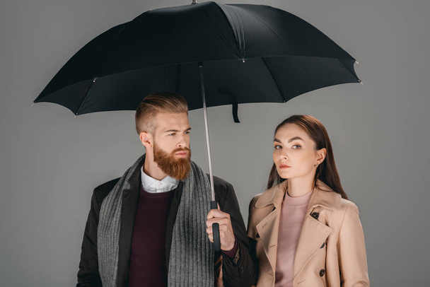 fashionable couple with umbrella - Zdjęcie, obraz