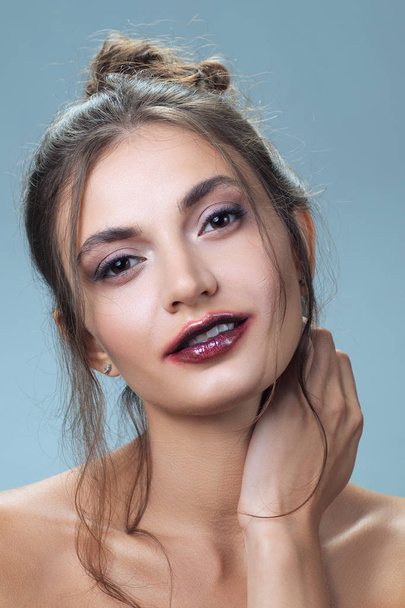 Portrait of beautiful girl with clean skin and smearing lipstick. Feathery lips and a strand of hair - Foto, afbeelding