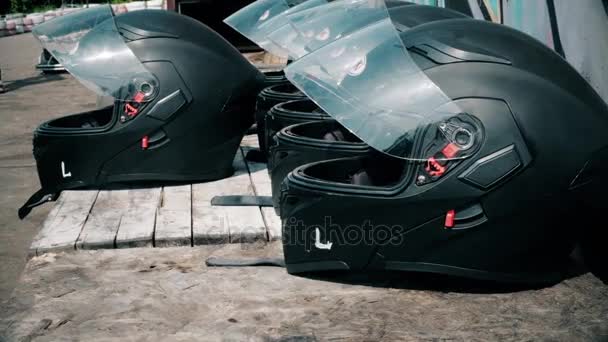 Car helmets lying on the table before the competition - Footage, Video