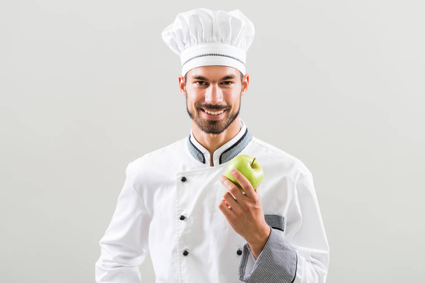 Chef showing apple  - Valokuva, kuva
