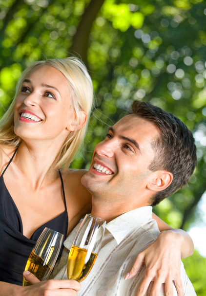couple celebrating with champagne, outdoors - Φωτογραφία, εικόνα