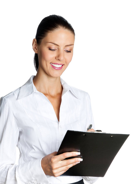 young businesswoman with clipboard writing, isolated - Foto, Imagen