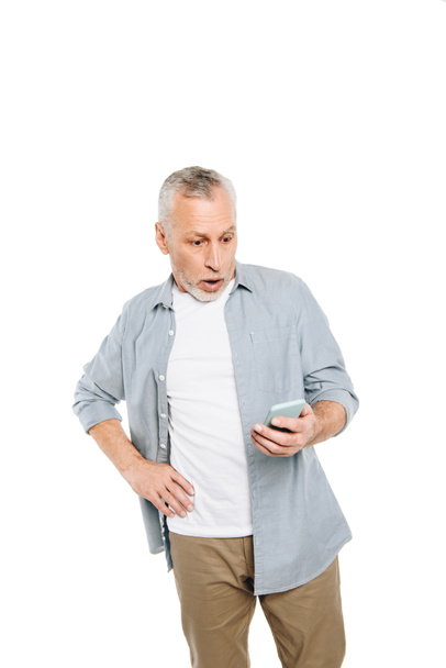 шокований чоловік зі смартфоном
 - Фото, зображення