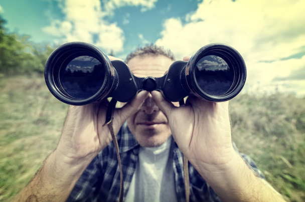 Man looking through binocular - Photo, Image