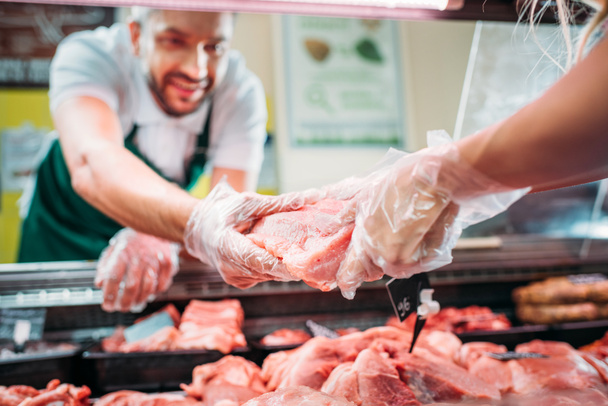 shop assistants with raw meat - Fotoğraf, Görsel