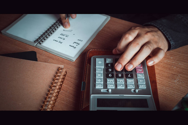Close up hand Asian man calculate finances and accounting for monthly expenses - Φωτογραφία, εικόνα
