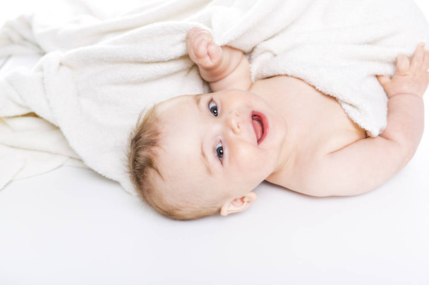 baby under a towel. isolated on a white background - Фото, зображення
