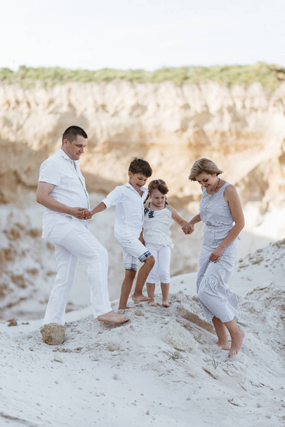 Happy family walking along the sandy places - Photo, Image