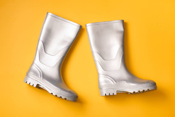 Silver rain boots on orange - Φωτογραφία, εικόνα