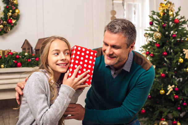 father and daughter with christmas gift - 写真・画像