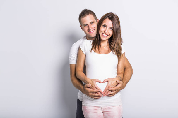 caucasian couple expecting baby smiling cheerful on white - Foto, Bild