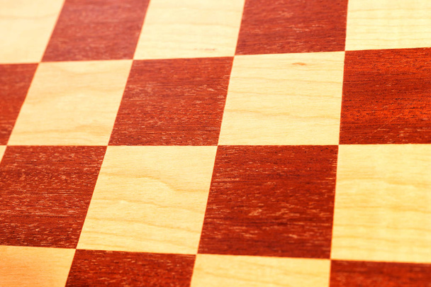 Dark and bright squares of a wooden chess board - Foto, immagini