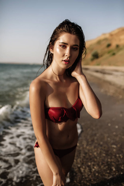 sexy girl of Asian appearance in her swimsuit on the sea with sand, fashion - Fotoğraf, Görsel