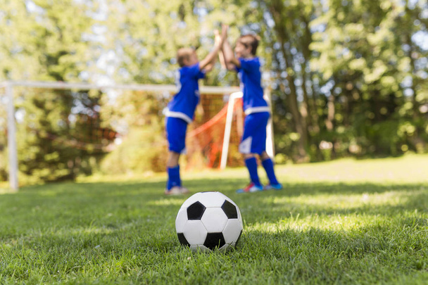 Two Young boy with soccer ball on a sport uniform - Photo, image