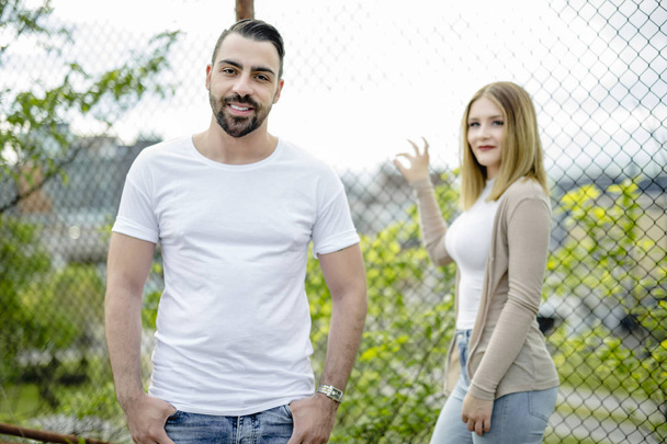 Couple close to a fence in a day - Foto, Bild