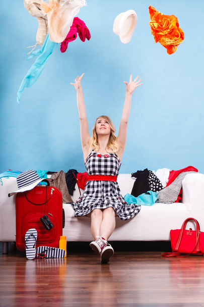Woman throwing up clothes, clothing flying everywhere - Foto, immagini