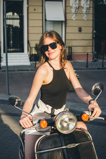 Woman in city with retro scooter - Zdjęcie, obraz
