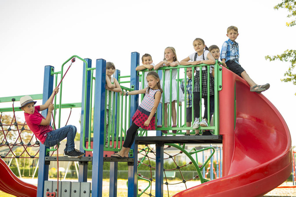 cheerful school age child play on playground school - Photo, image