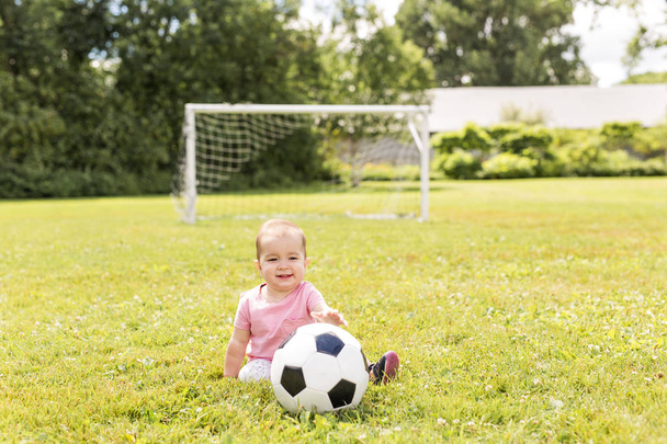 cute baby girl playing on grass with ball - Фото, зображення