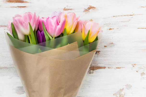 Tulipán csomagolni a barna papír-ra könnyű háttér - Fotó, kép