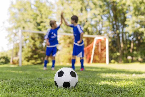 Two Young boy with soccer ball on a sport uniform - Zdjęcie, obraz