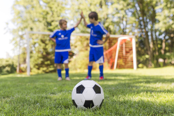 Two Young boy with soccer ball on a sport uniform - Photo, image