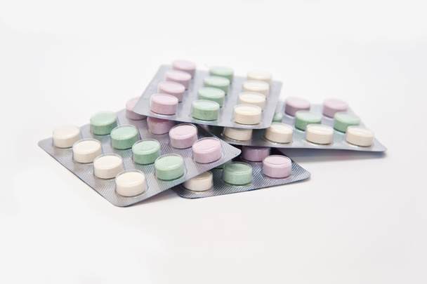 Colored pills on white background - Φωτογραφία, εικόνα