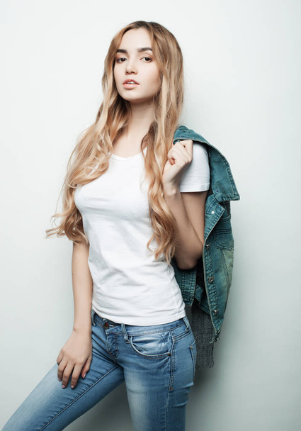 lifestyle, fashion and people concept: beautiful woman wearing casual clothes, posing on white background - 写真・画像