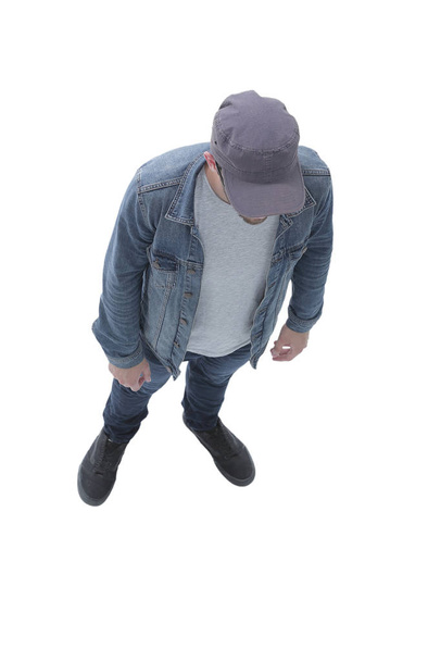 view from above. guy in a baseball cap and denim jacket - Foto, afbeelding