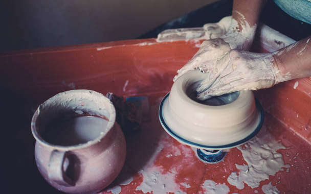 Work in a pottery workshop, womans hands creating ceramics. - Photo, Image
