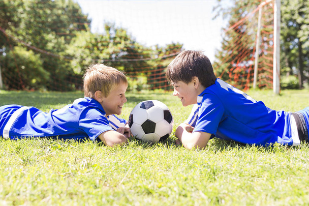 Two Young boy with soccer ball on a sport uniform - Fotoğraf, Görsel