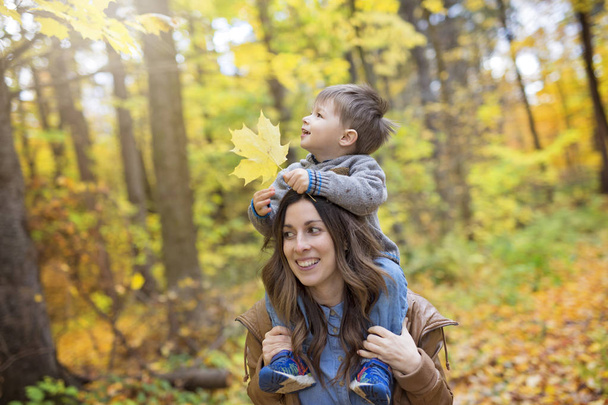 Mother with son in forest in autumn - Foto, immagini