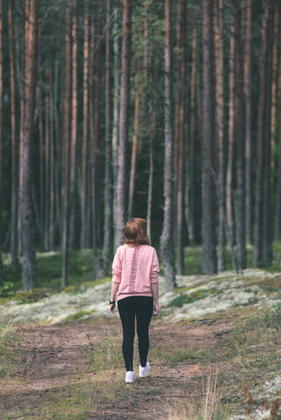 young woman enjoying nature in forest - vintage old look - Foto, imagen