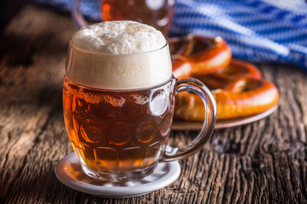 Beer and Oktoberfest. Draft beer pretzel and blue checkered tablecloth as traditional products for bavarian festival oktoberfest - Фото, зображення