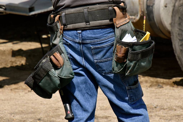 Carpenter standing with tool belt attached to his waist - Photo, Image