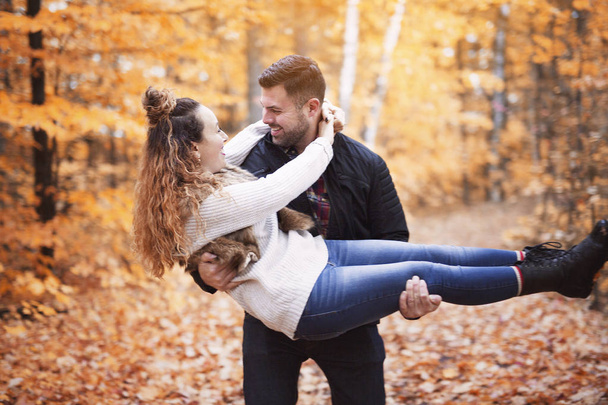 Nice couple having fun in autumn park - 写真・画像
