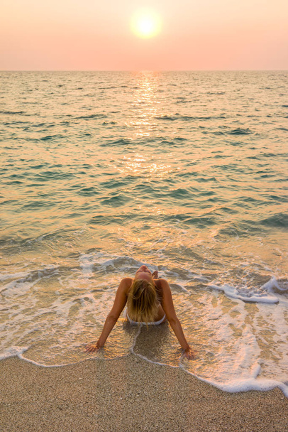 Woman in white bikini on the beach - Photo, image