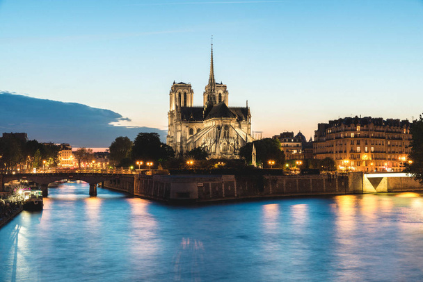 Notre dame de paris cathedral with Seine river at night in Paris - Photo, Image