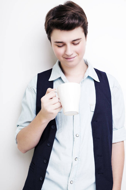 Coffee break. Confident young handsome man holding cup - Zdjęcie, obraz