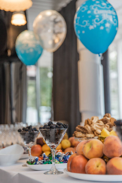 buffet at event with desert, fruits and balloons - Photo, Image