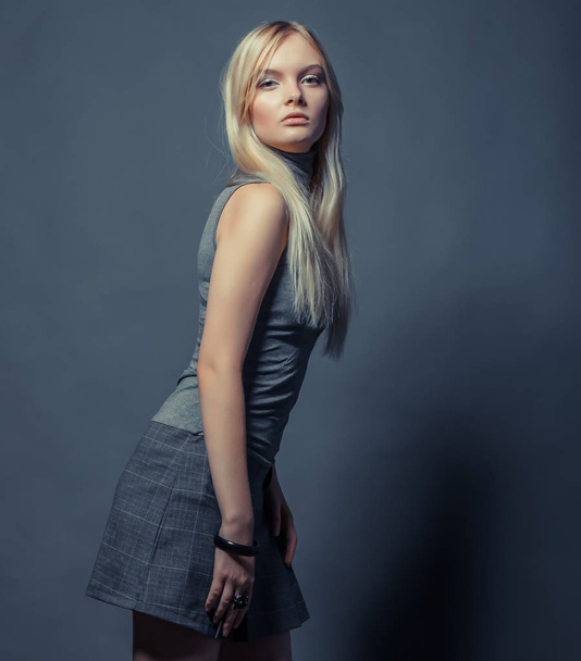 Portrait of beautiful young blonde girl in black dress. - Foto, imagen