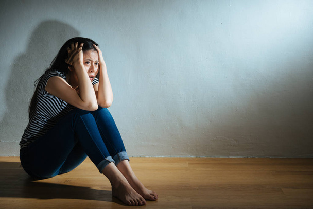 fear sadness victim girl sitting on wooden floor - Фото, изображение