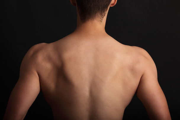 Muscular young sexy nude man on studio - Valokuva, kuva